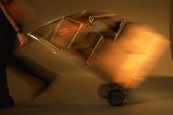 Image of a man wheeling goods